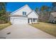 Inviting two-story home with a two-car garage and a pristine driveway, set against a serene backdrop at 105 Creekside Knl, Grantville, GA 30220