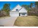 Charming white two-story home with a two-car garage and a well-manicured front yard at 105 Creekside Knl, Grantville, GA 30220