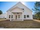 Back exterior of a white home with a covered back porch overlooking lawn at 105 Creekside Knl, Grantville, GA 30220