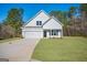 Charming white two-story home with attached garage and freshly landscaped front yard at 105 Creekside Knl, Grantville, GA 30220