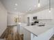 Modern kitchen featuring white cabinets, quartz countertops, and stainless steel appliances at 105 Creekside Knl, Grantville, GA 30220
