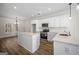Bright kitchen with white cabinets, stainless appliances, and a large center island at 105 Creekside Knl, Grantville, GA 30220