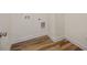 This laundry area features durable wood flooring and convenient utility connections at 105 Creekside Knl, Grantville, GA 30220