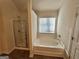 Bathroom featuring separate shower stall and soaking tub, offering a luxurious bathing experience at 3964 Riverchess Sw Dr # 157, Atlanta, GA 30331