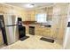 Well-lit kitchen with updated stainless steel appliances, cabinets, and tiled backsplash at 2326 Noahs Ark Rd, Jonesboro, GA 30236