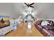 Bright bonus room with hardwood floors, vaulted ceiling, leather sofa, wall mounted television, and plenty of open space at 341 Beaumont Farms Dr, Sharpsburg, GA 30277