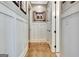 Hallway features wood floors, white wainscoting, and decorative accents at 341 Beaumont Farms Dr, Sharpsburg, GA 30277