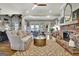 Bright living room featuring hardwood floors, a fireplace, and several large windows for natural lighting at 341 Beaumont Farms Dr, Sharpsburg, GA 30277