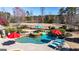 Outdoor swimming pool area with a spa, lake view, and lounge chairs at 341 Beaumont Farms Dr, Sharpsburg, GA 30277