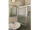 Bathroom featuring a single sink vanity, mirror, shower with glass door, and neutral walls at 4572 Sahara Sw Dr, Atlanta, GA 30331