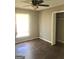Bedroom featuring wood-look floors, a window, and a closet with a ceiling fan at 4572 Sahara Sw Dr, Atlanta, GA 30331