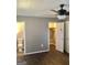 Bedroom featuring wood-look floors, neutral gray walls, closet, and access to a bathroom and closet at 4572 Sahara Sw Dr, Atlanta, GA 30331