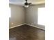 Bedroom featuring wood-look floors and neutral gray walls with two windows and a ceiling fan at 4572 Sahara Sw Dr, Atlanta, GA 30331