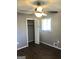 Bedroom with wood-look floors and neutral gray walls featuring a ceiling fan, closet, and window at 4572 Sahara Sw Dr, Atlanta, GA 30331