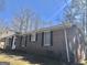 Side view of a brick home featuring symmetrical window placement and manicured landscaping at 4572 Sahara Sw Dr, Atlanta, GA 30331