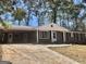 Charming single-story brick home featuring a covered carport and landscaped front yard at 4572 Sahara Sw Dr, Atlanta, GA 30331