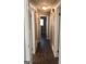Hallway featuring wood-look floors, white trim, doors to rooms, and a single light fixture at 4572 Sahara Sw Dr, Atlanta, GA 30331
