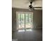 Spacious living room with a ceiling fan, neutral gray walls, and direct access to the backyard at 4572 Sahara Sw Dr, Atlanta, GA 30331