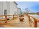 Wooden back deck featuring a fire pit, outdoor seating and beautiful waterfront views at 306 Turtle Pointe Dr, Carrollton, GA 30116