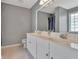 Bright bathroom featuring a double vanity with white cabinetry and a large mirror at 306 Turtle Pointe Dr, Carrollton, GA 30116