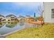 Backyard deck with views of the lake surrounded by green grass and other houses at 306 Turtle Pointe Dr, Carrollton, GA 30116