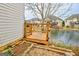 Backyard deck by the lake with wooden railings and steps at 306 Turtle Pointe Dr, Carrollton, GA 30116