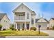 Charming two-story home featuring a welcoming front porch and attached two-car garage at 306 Turtle Pointe Dr, Carrollton, GA 30116