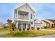 Charming two-story home featuring a welcoming front porch and attached two-car garage at 306 Turtle Pointe Dr, Carrollton, GA 30116
