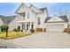 Beautiful two-story home featuring a welcoming front porch, and driveway leading to a two-car garage at 306 Turtle Pointe Dr, Carrollton, GA 30116