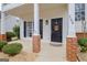 Inviting front porch with brick columns and decorative address numbers at 306 Turtle Pointe Dr, Carrollton, GA 30116