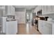 Well-lit kitchen with stainless steel appliances and white cabinets, offering ample storage at 306 Turtle Pointe Dr, Carrollton, GA 30116