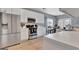Bright kitchen featuring stainless steel appliances, white cabinets, and wood flooring at 306 Turtle Pointe Dr, Carrollton, GA 30116