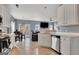Open-concept kitchen with a view of the dining area, stainless steel appliances, and wood flooring at 306 Turtle Pointe Dr, Carrollton, GA 30116