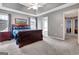 Spacious main bedroom with tray ceiling, ceiling fan, and access to ensuite bathroom at 306 Turtle Pointe Dr, Carrollton, GA 30116