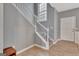 Elegant staircase with wood floors and white railing, complemented by a decorative window at 306 Turtle Pointe Dr, Carrollton, GA 30116