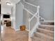 Inviting foyer with a staircase featuring carpeted steps and white railing leading to the upper level at 306 Turtle Pointe Dr, Carrollton, GA 30116