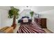 Bedroom featuring a bed, patterned rug, bright lighting, and dark wood furniture at 10119 Azalea Dr, Covington, GA 30014