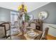 Elegant dining room with a large table, ornate chandelier, and stylish decor at 10119 Azalea Dr, Covington, GA 30014