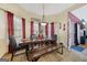 Dining room with large wooden table and bench seating and eye-catching pendant lighting at 10119 Azalea Dr, Covington, GA 30014