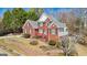 Beautiful two-story brick home featuring manicured landscaping and a charming front porch at 10119 Azalea Dr, Covington, GA 30014