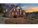 Beautiful brick home with manicured lawn, retaining wall, and lovely landscaping at 10119 Azalea Dr, Covington, GA 30014