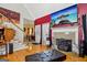 Cozy living room featuring hardwood floors, fireplace, and access to the dining room at 10119 Azalea Dr, Covington, GA 30014
