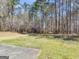 Landscaped backyard featuring a storage shed and mature trees at 290 Rocky Branch Dr, Mcdonough, GA 30252