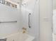 Bathroom featuring a jetted tub with tile surround, shower, and grab bar for safety at 290 Rocky Branch Dr, Mcdonough, GA 30252