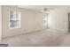 Bright bedroom with two windows and a ceiling fan for ample light and comfort at 290 Rocky Branch Dr, Mcdonough, GA 30252