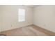 This bedroom features neutral walls and carpet with a window for natural light at 290 Rocky Branch Dr, Mcdonough, GA 30252