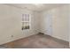 Cozy bedroom with a window and closet, featuring neutral walls and carpet at 290 Rocky Branch Dr, Mcdonough, GA 30252