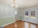 Dining area with wallpaper, hardwood floors, and access to the back yard through french doors at 290 Rocky Branch Dr, Mcdonough, GA 30252