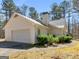 Well-maintained home featuring a side-entry garage and lush greenery at 290 Rocky Branch Dr, Mcdonough, GA 30252