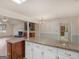 Kitchen area with granite countertop, white cabinets, and an open view to the Gathering room at 290 Rocky Branch Dr, Mcdonough, GA 30252